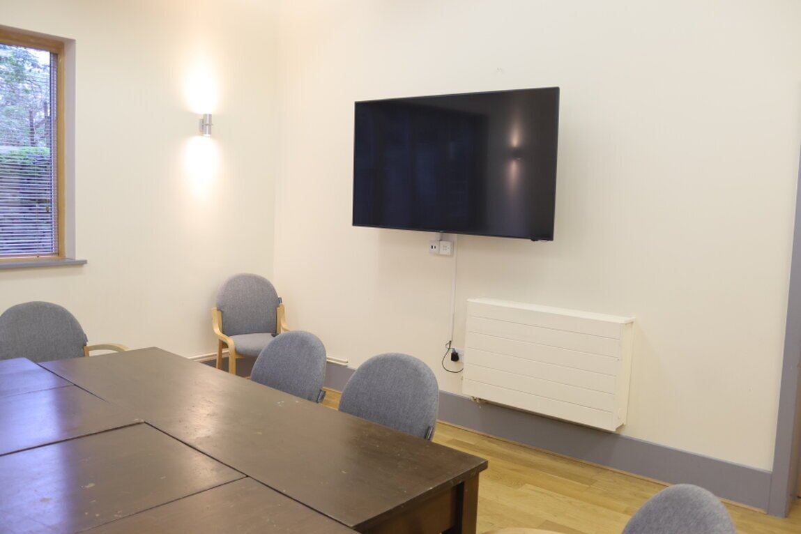 Community hall with large display and ceiling microphones